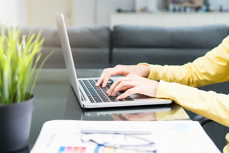 Person writing on a laptop
